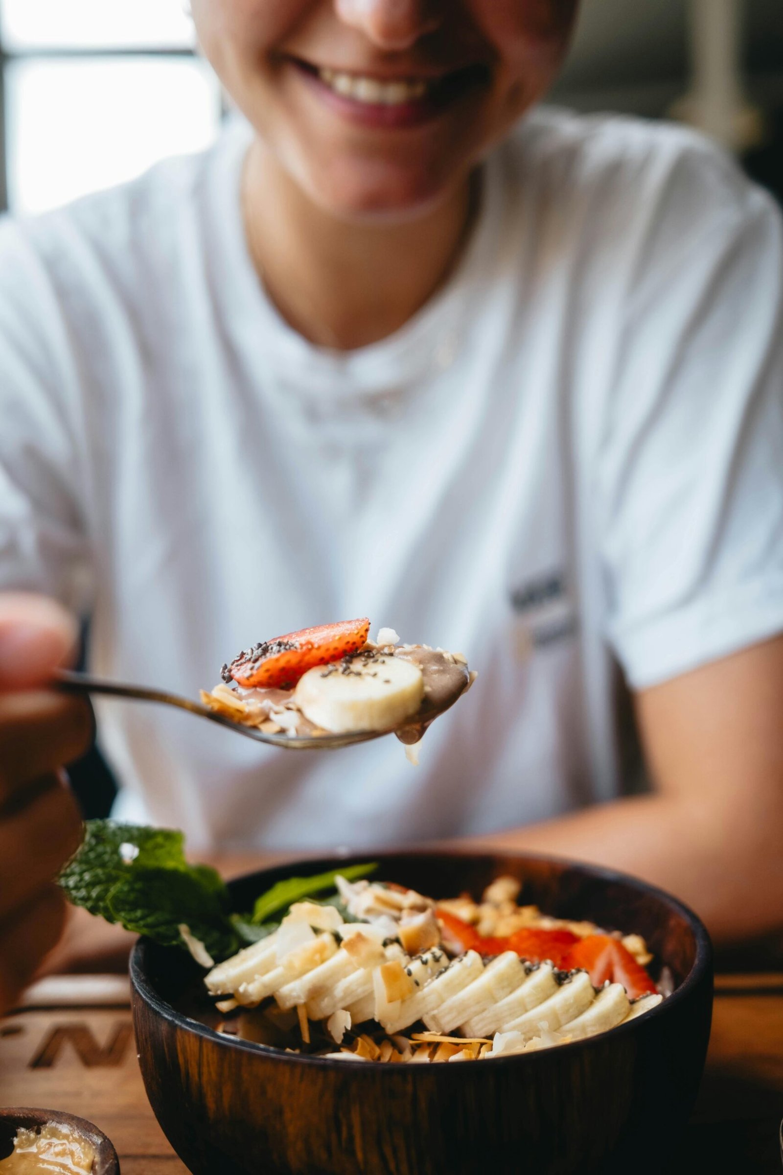 Enjoy a nutritious breakfast with fresh fruit and nuts in this vibrant bowl.